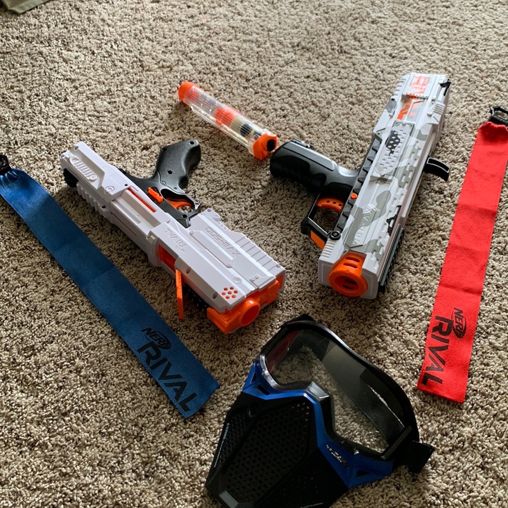 Nerf Rival-2 guns, 1 mask, a few balls (bullets) and 2 colored team flags.